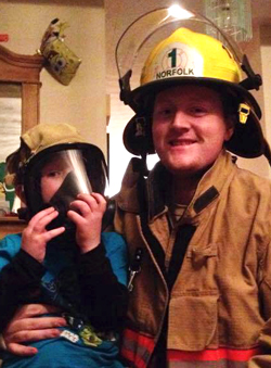 Martin with his son in his firefighter gear
